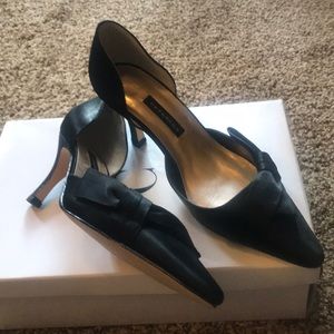 Black satin Caparros  bow on the side heels.